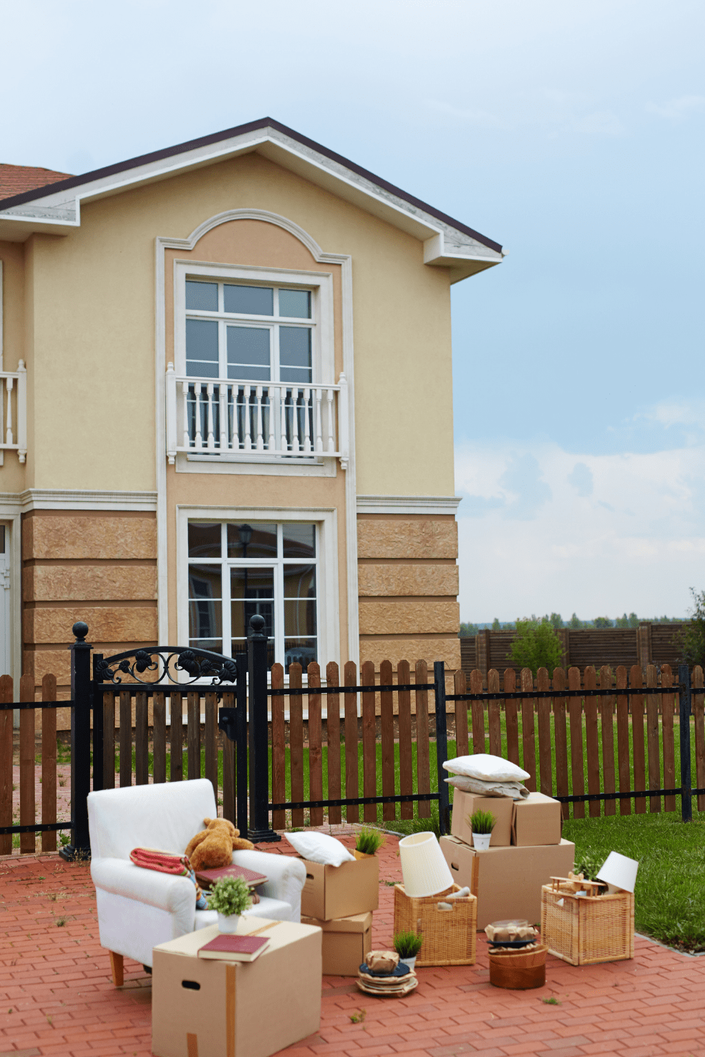 Packed boxes and household furniture placed outside a home on moving day